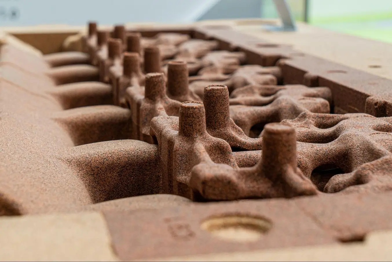 Sand core used to create internal cavities for cooling passages in an engine block